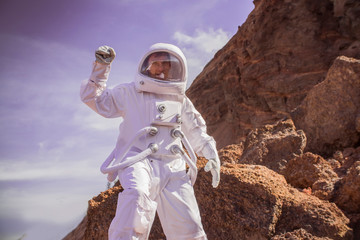 Courageous Astronaut in the Space Suit Explores Red Planet Mars Covered in Mist. Adventure. Space Travel, Habitable World and Colonization Concept
