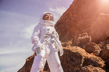Courageous Astronaut in the Space Suit Explores Red Planet Mars Covered in Mist. Adventure. Space Travel, Habitable World and Colonization Concept