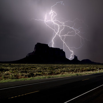 Composite photo of lightning striking behind Eagle Mesa off Highway 163 in 2016, near Monument Valley, Utah