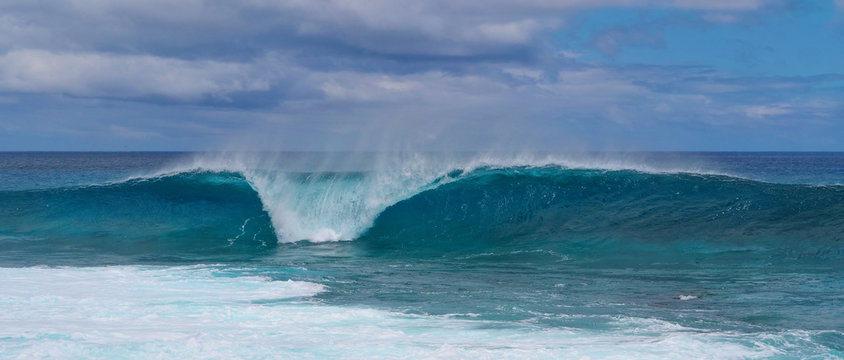 Turquoise breaking wave approaching the shoreline of beautiful Easter Island.