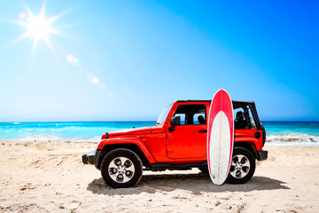Fototapeta na wymiar Summer red car on beach and sea landscape with blue sky and sun . 