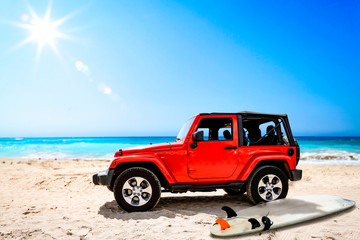Fototapeta premium Summer red car on beach and sea landscape with blue sky and sun . 