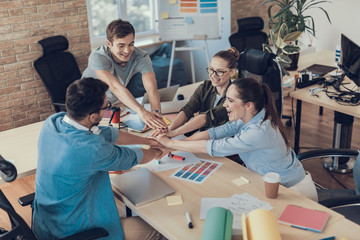 Happy employees with new project in office