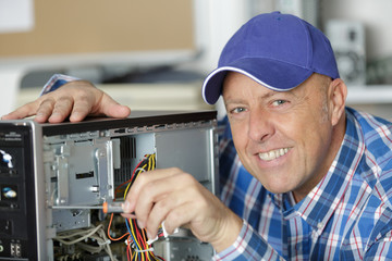 professional man repairing and assembling a computer