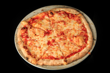 top view of whole sliced tasty pizza on round white plate