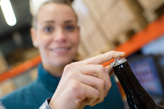 Female Brewer Opening Beer Bottle