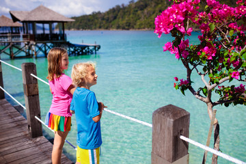 Fototapeta na wymiar Kids on tropical beach. Child on resort jetty.