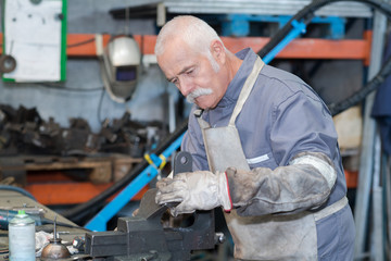 skilled senior engineer working in his workshop