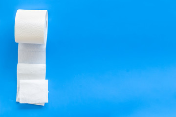 Toilet paper for proctology diseases concept on blue background top view mockup