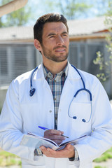 portrait of handsome male doctor outdoors