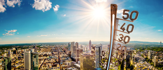 Panorama of Frankfurt am Main on a hot summer day with bright sun and big thermometer