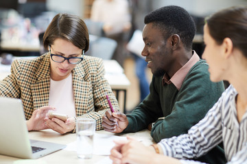 Multi-ethnic group of young business people working together in office, copy space
