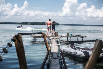 Obraz premium two on the pier on a bright Sunny day