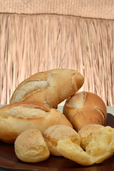 french bread and cheese bread on the plate with red background