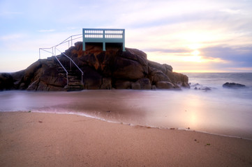 View point or gazebo over the rocks on a beach in Vila do Conde, Portugal, at sunset.