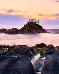 View point or gazebo over the rocks on a beach in Vila do Conde, Portugal, at sunset.