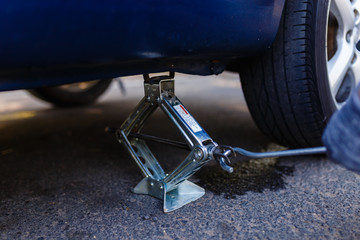 Closeup of metal keeps the car Jack to change a flat tire