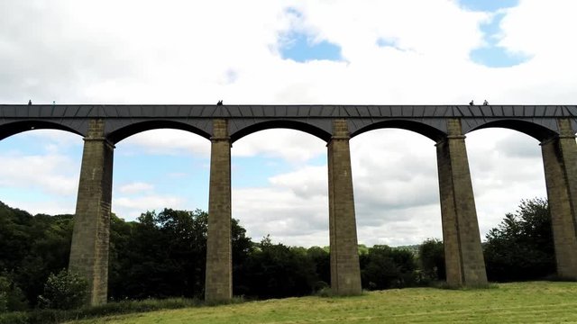 Pontcysyllte Aqueduct arch bridge canal waterway crossing, Low angle, tilt up aerial view under arches.