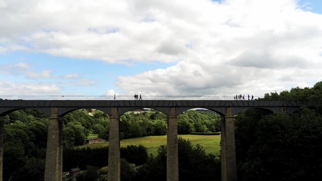 Pontcysyllte Aqueduct arch bridge canal waterway crossing, Pull back reveal aerial.