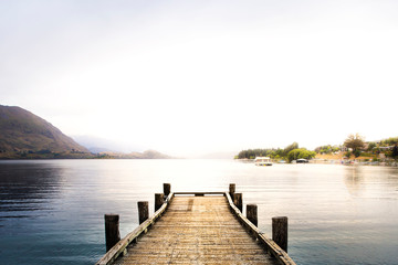 wooden pier on the lake at sunrise sunset