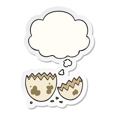 cartoon cracked egg and thought bubble as a printed sticker