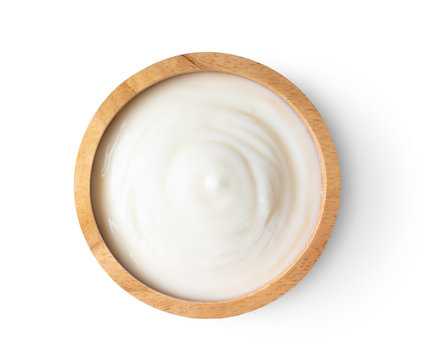 wood bowl of yogurt isolated on white background from top view
