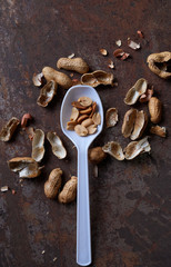 Peeled peanut on the rusty metal floor