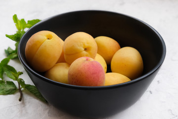 Fresh summer fruits. Bowl of ripe sweet apricots.