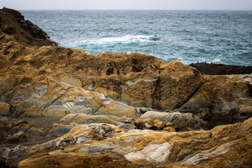 Fototapeta na wymiar Colorful Rock Formations on California Coast with Ocean