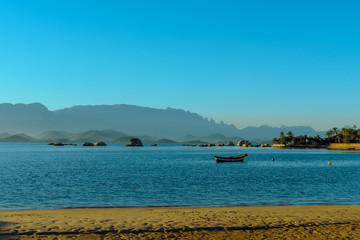 Sunset at Paqueta Beach in Rio de Janeiro with mountains in the background