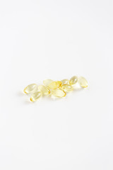 Group of Yellow Pills on White Background, CBD Capsules, Vitamins