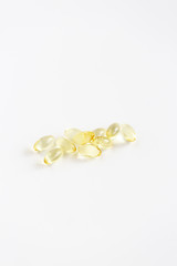 Group of Yellow Pills on White Background, CBD Capsules, Vitamins