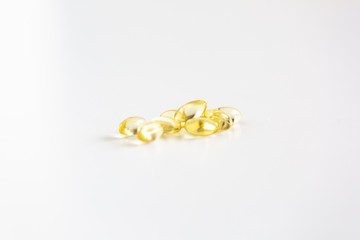 Group of Yellow Pills on White Background, CBD Capsules, Vitamins