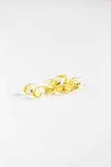 Group of Yellow Pills on White Background, CBD Capsules, Vitamins