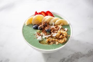 Spirulina yogurt with fruit in wooden bowl