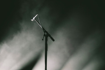 Microphone on a stand with stage light and smoke 
