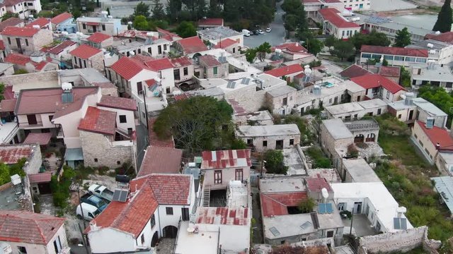 Flying above the beautiful life city located on the hills in the lovley nature. Drone view of the wonderful city architecture located on the island. Summer trip to Pano Lefkara, Cyprus