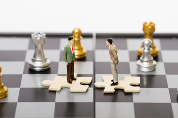 Chess business people with puzzles, competition and cooperation