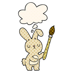 cartoon rabbit with paint brush and thought bubble in comic book style