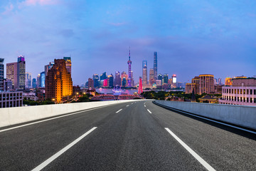 Shanghai skyline panoramic view with asphalt highway at night,China