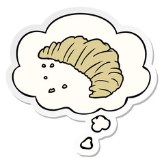 cartoon croissant and thought bubble as a printed sticker