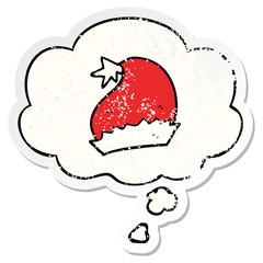 cartoon santa hat and thought bubble as a distressed worn sticker