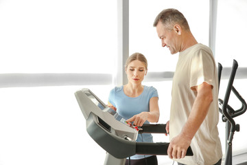 Physiotherapist working with mature patient in rehabilitation center