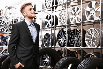 Male seller in car tire store