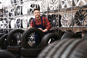Male seller in car tire store