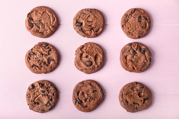 Tasty chocolate cookies on color background