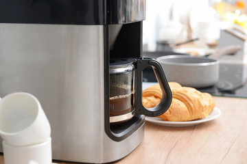 Modern coffee machine on kitchen table, closeup