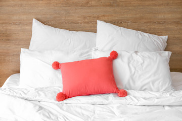 Fototapeta na wymiar Soft pillows on bed in room