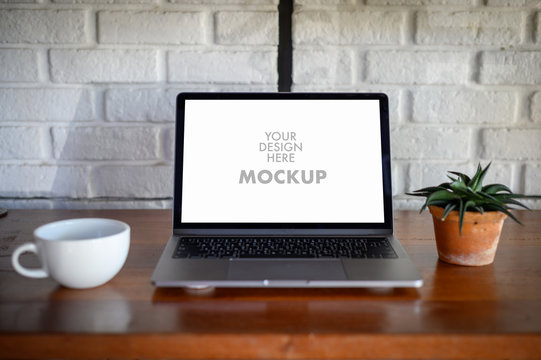 Mockup of business man using laptop screen for your advertising text message Laptop with blank screen on table compute work
