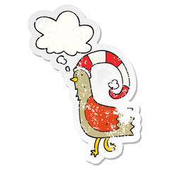 cartoon chicken in funny christmas hat and thought bubble as a distressed worn sticker